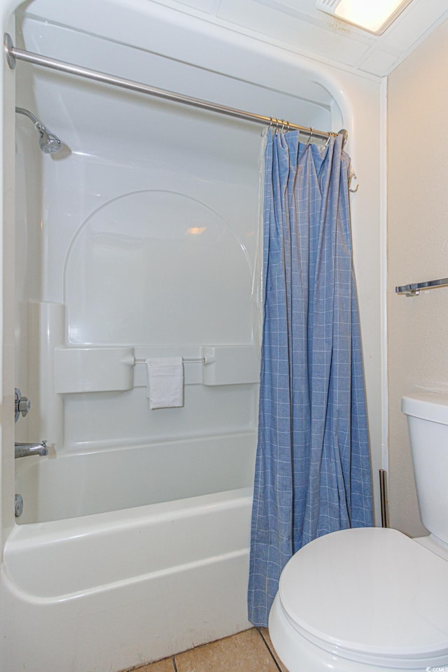 bathroom with toilet, shower / bath combination with curtain, and tile patterned floors