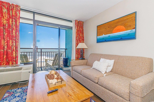 living room with wood finished floors, floor to ceiling windows, and plenty of natural light