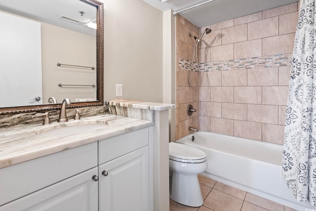 full bathroom featuring tile patterned flooring, shower / tub combo with curtain, toilet, and vanity