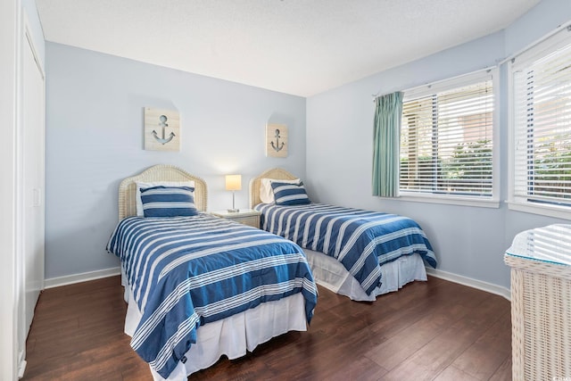bedroom featuring wood finished floors and baseboards