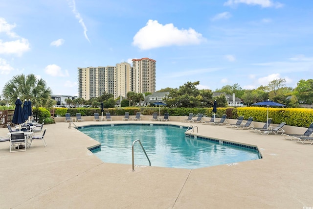 community pool with a patio area
