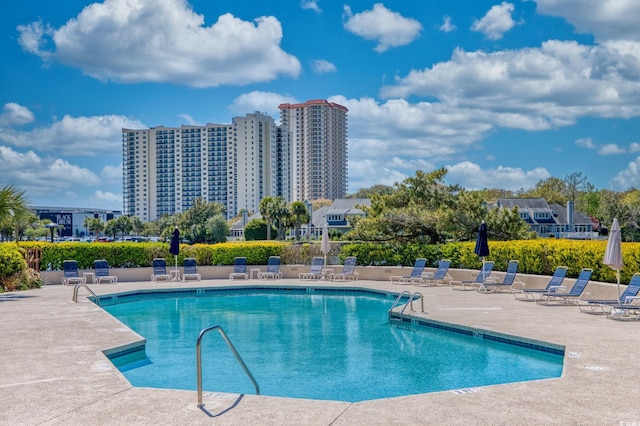 community pool with a patio area
