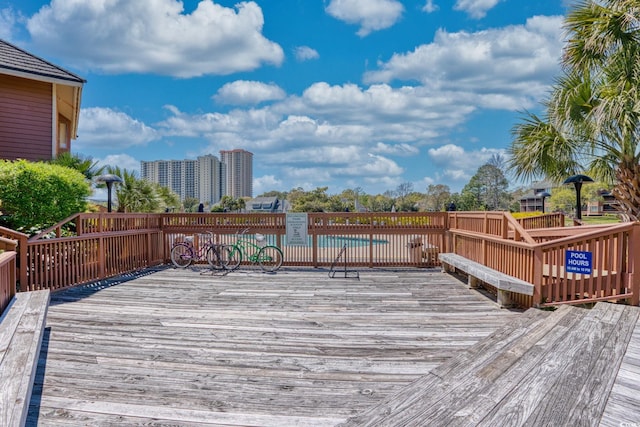 wooden deck featuring a community pool