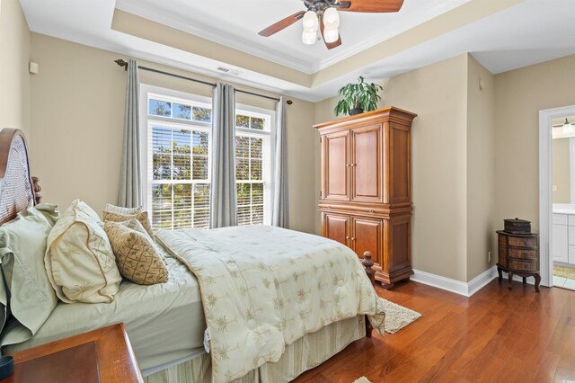 2213 Gazebo Ct, North Myrtle Beach, SC 29582 - bedroom with a raised ceiling, dark wood-type flooring, crown molding, baseboards, and ensuite bath
