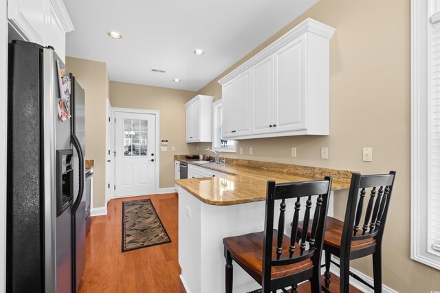 2213 Gazebo Ct, North Myrtle Beach, SC 29582 - kitchen featuring appliances with stainless steel finishes, a peninsula, white cabinets, a sink, and recessed lighting