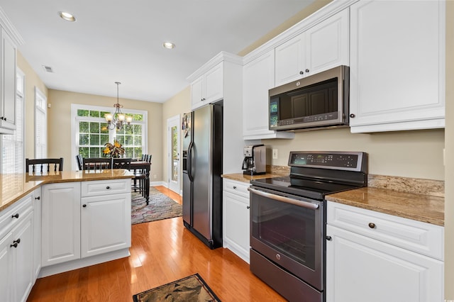 2213 Gazebo Ct, North Myrtle Beach, SC 29582 - kitchen featuring appliances with stainless steel finishes, a chandelier, light wood finished floors, white cabinets, and recessed lighting