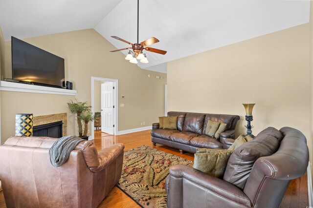 2213 Gazebo Ct, North Myrtle Beach, SC 29582 - living area with ceiling fan, light wood finished floors, high vaulted ceiling, a tile fireplace, and baseboards