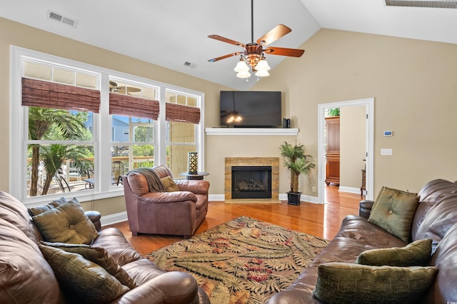 2213 Gazebo Ct, North Myrtle Beach, SC 29582 - living area with a ceiling fan, wood finished floors, a glass covered fireplace, and high vaulted ceiling