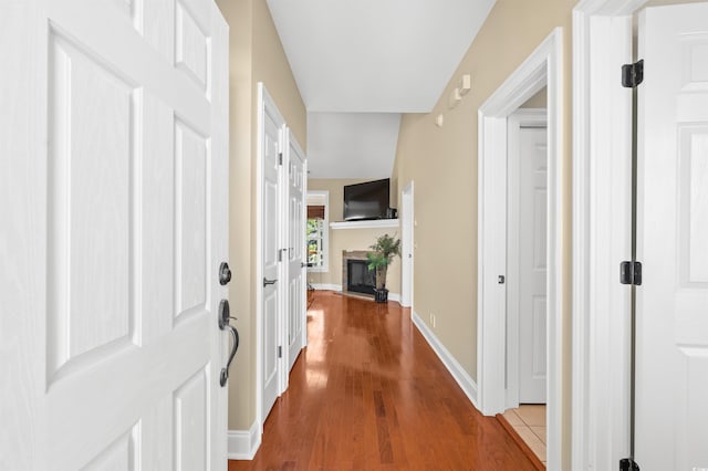 2213 Gazebo Ct, North Myrtle Beach, SC 29582 - foyer entrance featuring a glass covered fireplace, wood finished floors, and baseboards