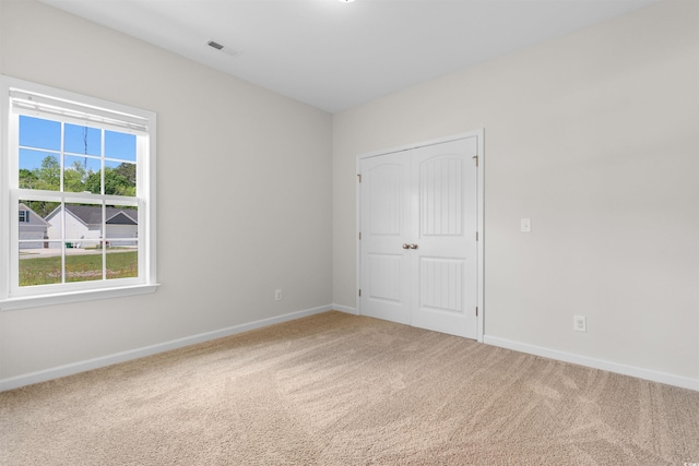 carpeted empty room with baseboards