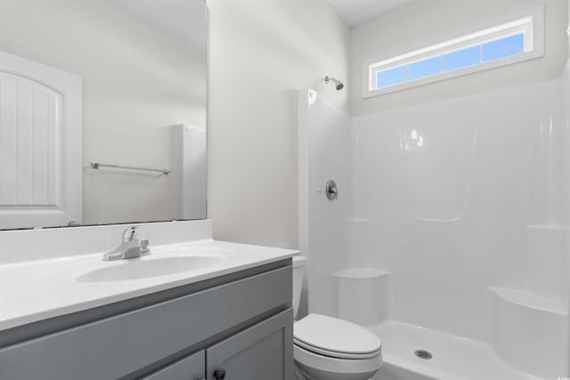 full bath featuring a shower, vanity, and toilet