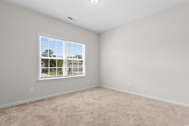 carpeted spare room with baseboards