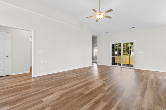 unfurnished room with ceiling fan, wood finished floors, high vaulted ceiling, and baseboards