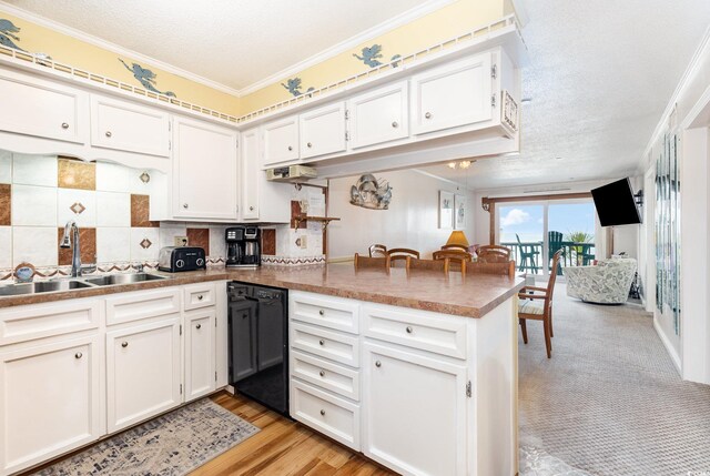 1310 N Waccamaw Dr Unit 211, Garden City Beach, SC 29576 - kitchen with a sink, dishwasher, a peninsula, crown molding, and white cabinets