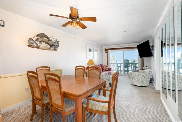 1310 N Waccamaw Dr Unit 211, Garden City Beach, SC 29576 - dining room with light colored carpet, ceiling fan, ornamental molding, and baseboards
