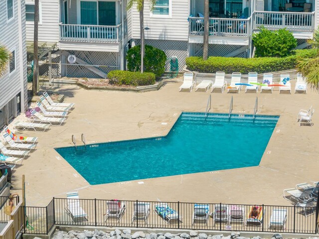 1310 N Waccamaw Dr Unit 211, Garden City Beach, SC 29576 - community pool featuring a patio and fence