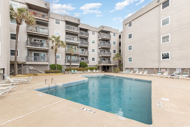 community pool with a patio area
