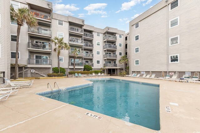 1310 N Waccamaw Dr Unit 211, Garden City Beach, SC 29576 - community pool with a patio area