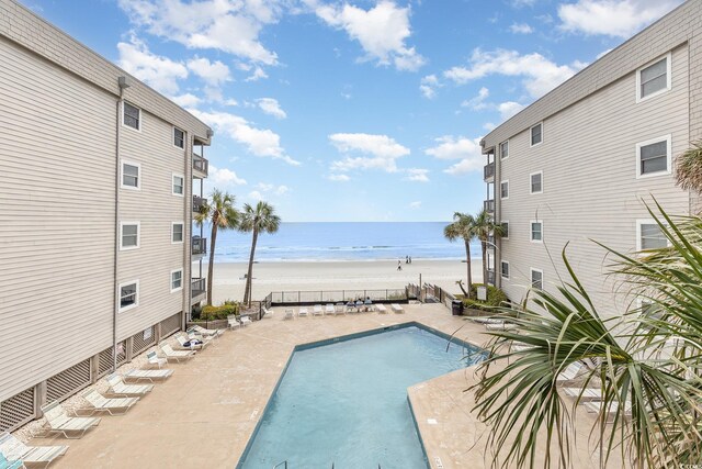 1310 N Waccamaw Dr Unit 211, Garden City Beach, SC 29576 - community pool with view of water and beach and a patio area