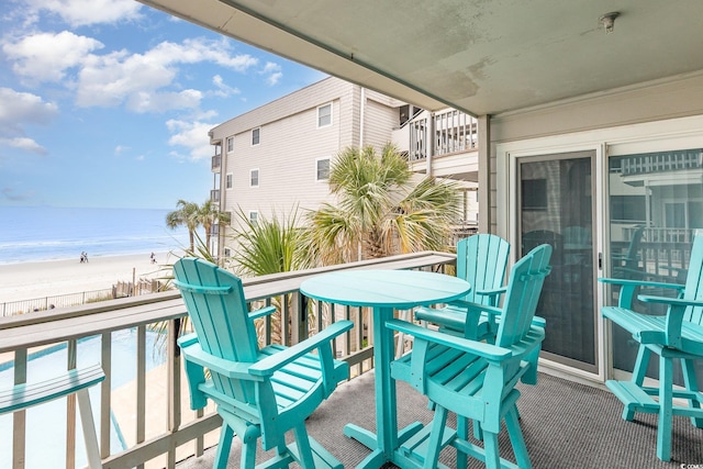 balcony with view of water and beach