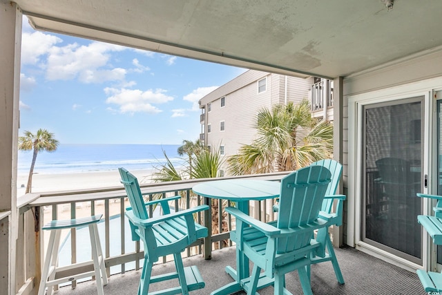 balcony with view of water and beach