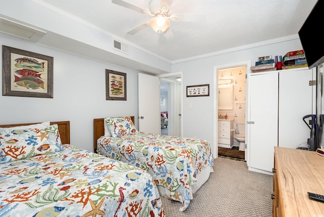 bedroom with crown molding, light colored carpet, ceiling fan, ensuite bath, and attic access