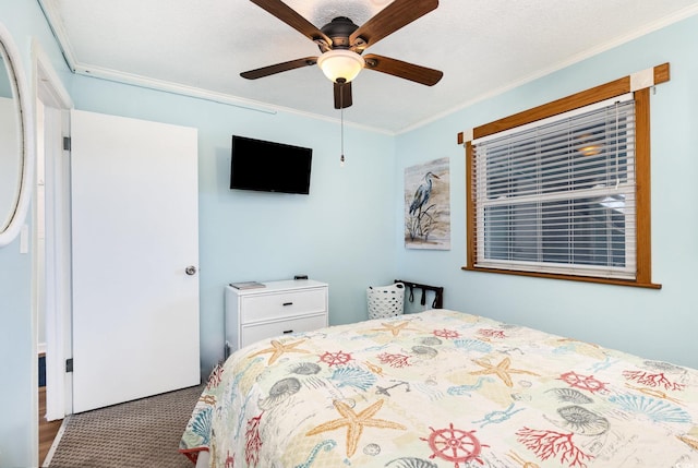 bedroom with ornamental molding, carpet floors, and a ceiling fan