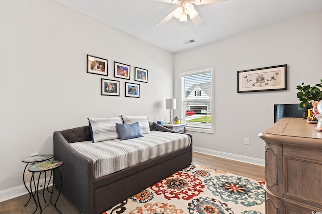 bedroom with baseboards, visible vents, a ceiling fan, and light wood-style floors