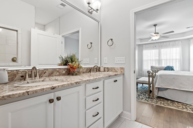 full bathroom featuring double vanity, ceiling fan, visible vents, and a sink