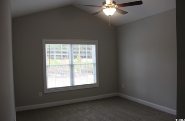 carpeted spare room featuring baseboards, vaulted ceiling, and ceiling fan