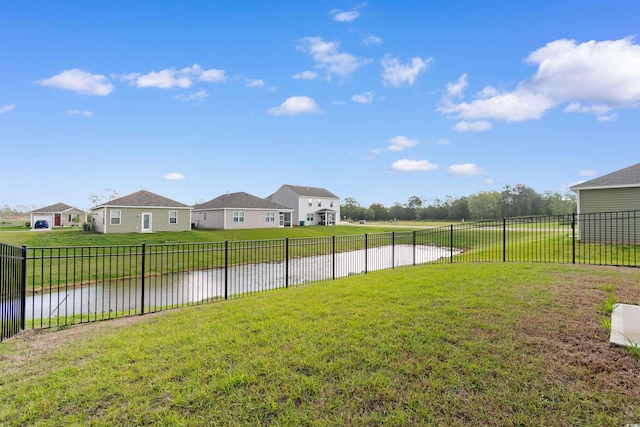 view of yard featuring a water view and a residential view