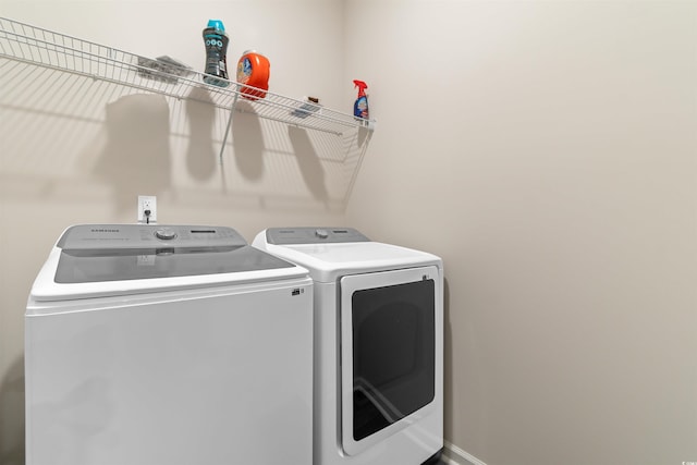 clothes washing area with washer and clothes dryer