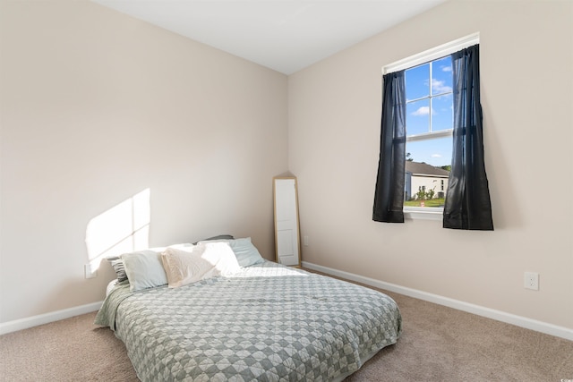 carpeted bedroom with baseboards