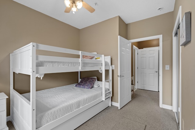 carpeted bedroom with a ceiling fan and baseboards