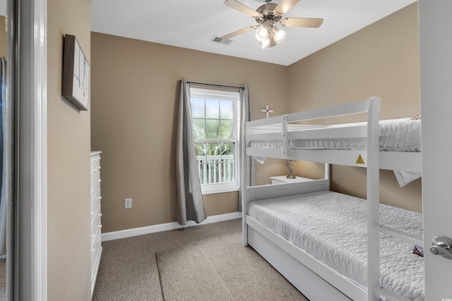 bedroom with baseboards, light colored carpet, ceiling fan, and visible vents