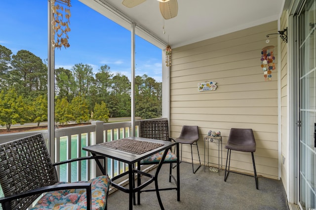 sunroom featuring a ceiling fan