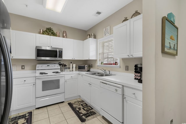 kitchen featuring a sink, appliances with stainless steel finishes, and white cabinetry