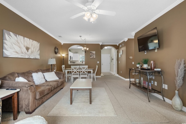 living area with crown molding, arched walkways, ceiling fan, and light carpet