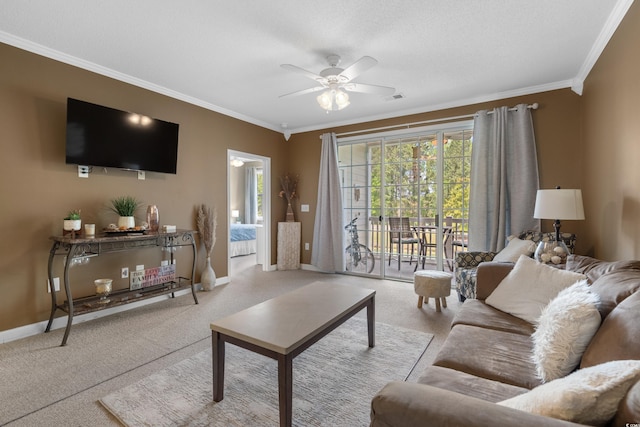 living area with visible vents, ornamental molding, baseboards, ceiling fan, and carpet flooring