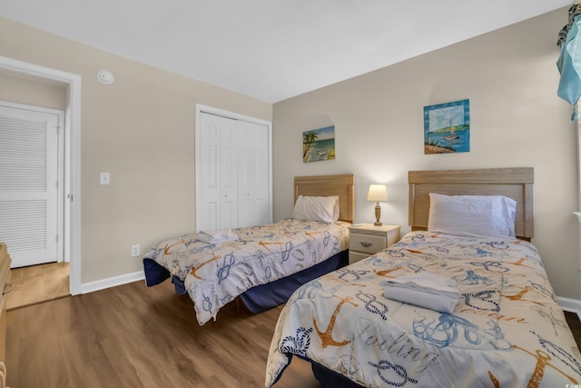 bedroom featuring baseboards, a closet, and wood finished floors