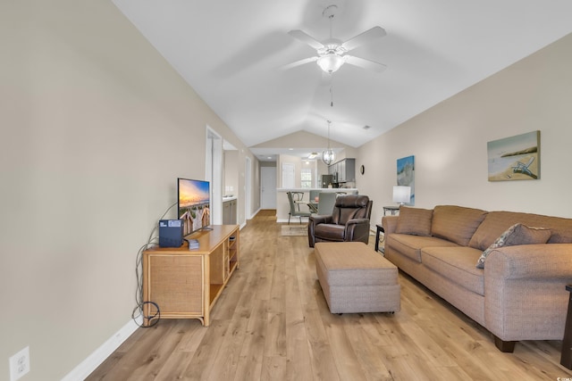 living room featuring baseboards, a ceiling fan, light wood finished floors, and lofted ceiling