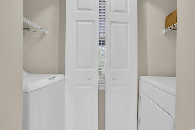 washroom featuring separate washer and dryer and laundry area