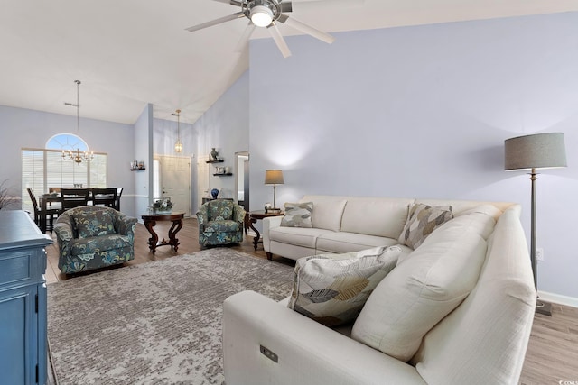 1752 Starbridge Dr, Surfside Beach, SC 29575 - living area with high vaulted ceiling, ceiling fan with notable chandelier, baseboards, and wood finished floors
