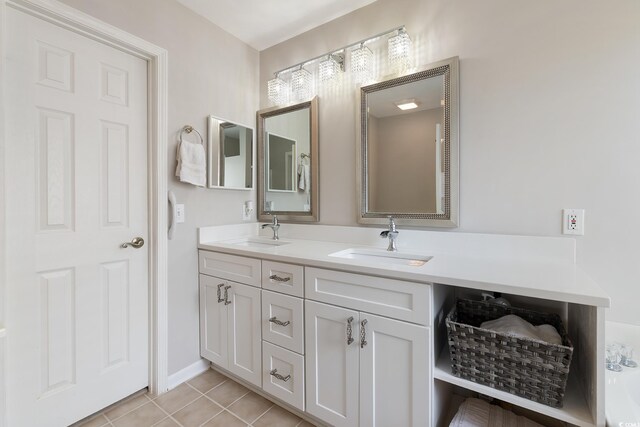 1752 Starbridge Dr, Surfside Beach, SC 29575 - bathroom with tile patterned floors, double vanity, a sink, and baseboards