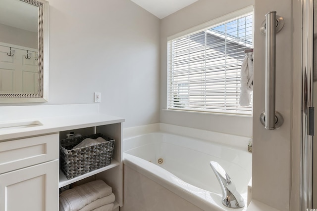 1752 Starbridge Dr, Surfside Beach, SC 29575 - bathroom with a healthy amount of sunlight, vanity, and a tub with jets