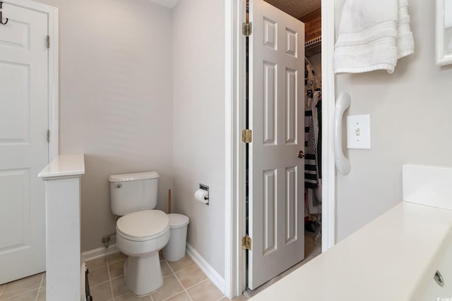 1752 Starbridge Dr, Surfside Beach, SC 29575 - bathroom with toilet, tile patterned floors, a walk in closet, and baseboards