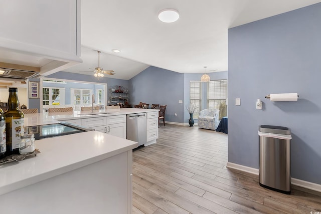 1752 Starbridge Dr, Surfside Beach, SC 29575 - kitchen featuring white cabinets, baseboards, dishwasher, a sink, and light countertops