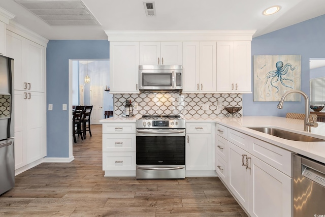 1752 Starbridge Dr, Surfside Beach, SC 29575 - kitchen featuring a sink, visible vents, light countertops, and stainless steel appliances