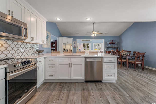 1752 Starbridge Dr, Surfside Beach, SC 29575 - kitchen featuring a sink, light countertops, ceiling fan, vaulted ceiling, and stainless steel appliances