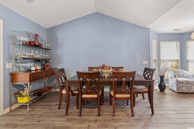 1752 Starbridge Dr, Surfside Beach, SC 29575 - dining space featuring wood finished floors, visible vents, and vaulted ceiling